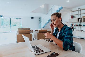 Image showing Woman sitting in living room using laptop look at cam talk by video call with business friend relatives, head shot. Job interview answering questions.