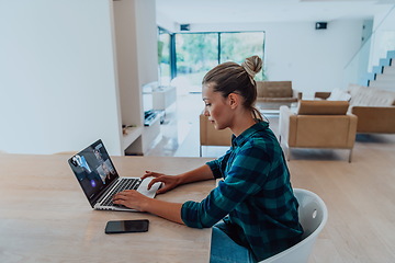 Image showing Woman sitting in living room using laptop look at cam talk by video call with business friend relatives, head shot. Job interview answering questions.