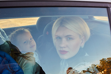 Image showing Family concept. Portrait of mother and daughter through the glass of a car