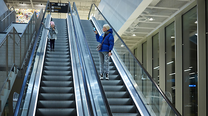 Image showing Mother and child together on escalator background. Terminal, airport travel, love care.