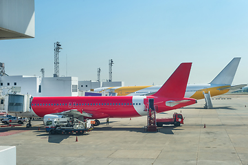 Image showing Loading airplanes at airport runway 