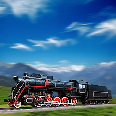 Image showing Speeding old locomotive in mountains with motion blur