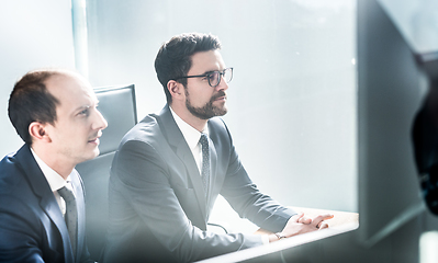 Image showing Business team analyzing data at business meeting in modern corporate office.