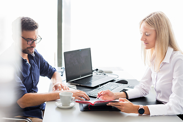 Image showing Business meeting. Client consulting. Confident business woman, real estate agent, financial advisor explaining details of project or financial product to client in office.