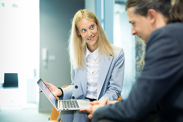 Image showing Business meeting. Client consulting. Confident business woman, real estate agent, financial advisor explaining details of project or financial product to client in office.