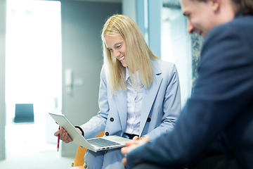 Image showing Business meeting. Client consulting. Confident business woman, real estate agent, financial advisor explaining details of project or financial product to client in office.