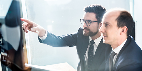 Image showing Business team analyzing data at business meeting in modern corporate office.