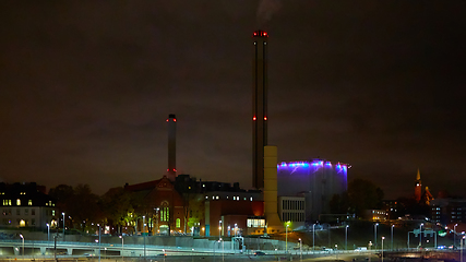 Image showing Modern grain terminal at night. Metal tanks of elevator. Grain-drying complex construction. Commercial grain or seed silos at seaport. Steel storage for agricultural harvest