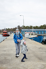 Image showing Daughter and mother have fun on pier.