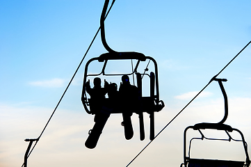 Image showing people on chairlift with skis