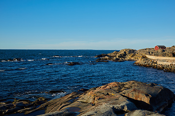 Image showing Red house at sea shore in the baltic sea in dull colors in autumn.