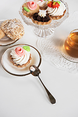 Image showing Cakes with tea on white