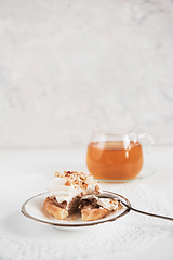 Image showing Cakes with tea on white