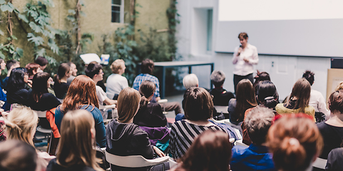 Image showing Woman giving presentation in lecture hall at university.