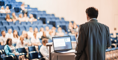 Image showing Speaker giving a talk on corporate business conference. Unrecognizable people in audience at conference hall. Business and Entrepreneurship event.