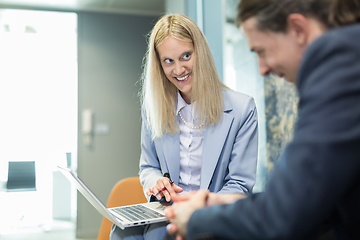 Image showing Business meeting. Client consulting. Confident business woman, real estate agent, financial advisor explaining details of project or financial product to client in office.