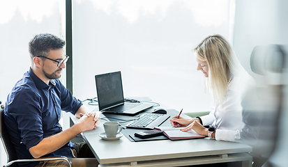 Image showing Business meeting. Client consulting. Confident business woman, real estate agent, financial advisor explaining details of project or financial product to client in office.