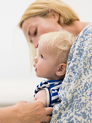 Image showing Child beeing vaccinated by pediatrician in presence of his mother. Preventive vaccination against Diphtheria, whooping cough, tetanus, hepatitis, haemophilus influenzae, pneumococcus, poliomyelitis