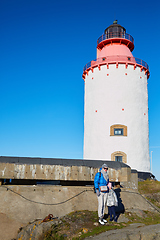 Image showing Beautiful woman posing near lighthouse. Travel the world concept