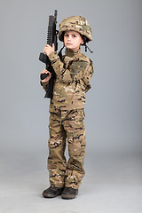 Image showing Young boy dressed like a soldier with rifle