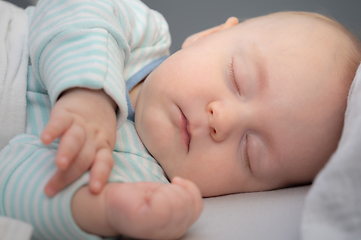 Image showing Baby boy sleeping in his bed