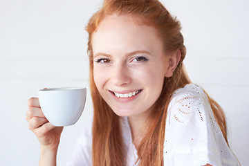 Image showing Happy, smile and portrait of a woman with coffee in a studio in the morning on a weekend. Happiness, excited and face of a female model drinking a cappuccino, caffeine or latte by a white background.