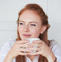 Image showing Thinking, calm and woman with a cup of coffee in a studio for relax in the morning on a weekend. Dreaming, memory and face of a female model drinking cappuccino, caffeine or latte by white background