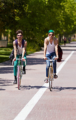 Image showing Bicycle, travel and men friends in a city street riding, bond and enjoying freedom on holiday or vacation together. Cycling, bike and people in a road with freedom, adventure and neighborhood hangout