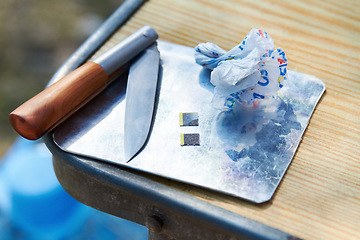 Image showing Drugs, closeup and lsd strips on table for psychedelic, trippy and addiction outdoors in park. Danger, narcotics and equipment for habit, gateway and substance abuse or unhealthy micro dosing