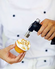 Image showing Baker, torch and flame in restaurant for dessert, cake or meringue in kitchen for fine dining experience. Fire, cupcake and pastry chef in cafe, coffee shop or small business for cooking luxury food