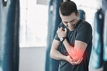 Image showing Hand, elbow pain and injury with the arm of a man in red highlight during a fitness workout. Healthcare, medical and emergency with a young male athlete holding a joint after an accident in the gym