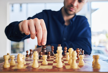 Image showing Chess, man moving a piece and game of strategy, problem solving or person playing on chessboard in competition. Planning, choice and hand on knight or king, queen and player thinking of winning move