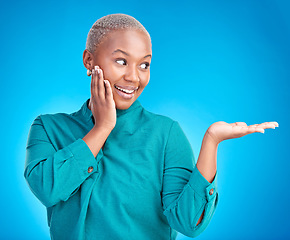 Image showing Decision, smile and black woman showing, presentation and promotion against a blue studio background. Sales, female person or model with discount deal, excited and choice with advertising and options