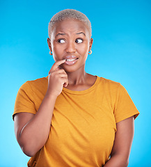Image showing Black woman, biting nails and anxiety in studio with thinking, confused or ideas for decision by blue background. African girl, stress and finger in mouth for fear, scared or brainstorming for choice