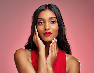 Image showing Woman, portrait and face with makeup on valentines day for beauty against a studio background. Female person or model touching perfect skin in facial treatment, cosmetics or skincare of lady in red