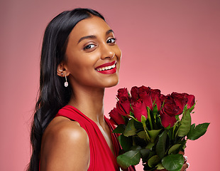 Image showing Happy, beauty and portrait of a woman with a rose on a studio background for valentines day. Makeup, model and face of a young Indian girl with a flower bouquet for romance or love on pink backdrop