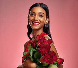 Image showing Happy, flowers and portrait of an Indian woman on a studio background for valentines day. Smile, beautiful and a young model or girl with a floral bouquet on a backdrop for luxury present of roses