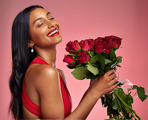 Image showing Happy, beauty and face of a woman with a roses on a studio background for valentines day. Makeup, model and young Indian girl with a flower bouquet and laugh for romance or love on a pink backdrop