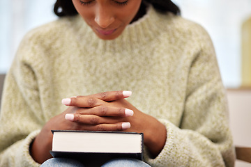 Image showing Bible, hands and woman praying for help, faith or gratitude to God, praise and humble in her home. Jesus, worship and lady person in prayer for religious, hope or trust, Christian and spiritual guide