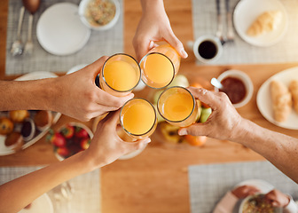 Image showing Brunch, hands or people toast with orange juice, beverage or glass drink at lunch, breakfast or food meal. Fruit liquid, top view group or home friends celebrate, support or toasting at reunion event