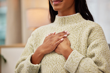 Image showing Closeup of a woman holding her chest while breathing for calm, peace and zen mindset for meditation. Breathe, relax and zoom of a female person hands on her heart for grateful gesture in living room.