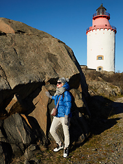 Image showing Beautiful woman posing near lighthouse. Travel the world concept