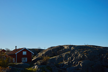 Image showing Red house at sea shore in the baltic sea in dull colors in autumn.