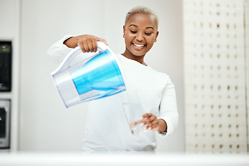 Image showing Black woman, pitcher and glass with water filter for clean and fresh purification at home. Happy female person pouring healthy aqua beverage for nutrition, drinking and cold filtration jug in kitchen