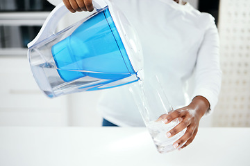 Image showing Hands, jug and glass of filter water to refresh with pure liquid hydration at home. Closeup, thirsty person and pouring healthy aqua beverage in container for nutrition, drinking and cold filtration