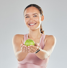 Image showing Portrait, apple and offer of woman isolated on studio, white background for healthy food, healthcare or nutritionist diet. Face of vegan person or model giving green fruit for detox, care and choice