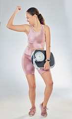 Image showing Scale, success and strong woman with fitness, lose weight progress and body goals or fist, power and bodybuilder. Sports person or model for achievement, diet and yes sign on studio, white background