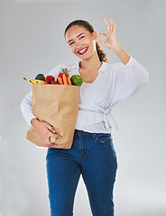 Image showing Groceries, okay sign and woman in portrait with food excellence and promotion, sale or discount. Person, bag and grocery shopping, healthy fruits and vegetable and ok emoji on studio white background