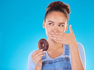 Image showing Chocolate, diet and donut with woman in studio for fast food, dessert and nutrition. Happy, cake and sugar with person eating on blue background for candy, health and hungry with mockup space