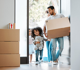Image showing Happy family, box and moving in new home for real estate, property investment or mortgage loan by door. Father, mother and children walk in house with package for relocation, renovation or start life